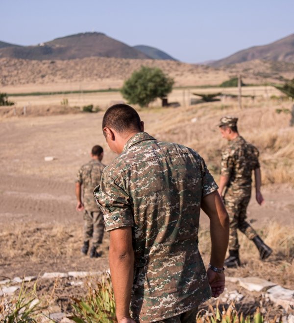Nagorno-Karabakh, Republic of Artsakh - 08/03/2019 - Three soldiers of the Artsakh Defense Army walking on dirt road in their off time