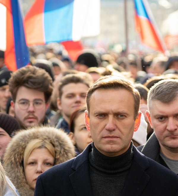 Lyubov Sobol abd Alexei Navalny on march in memory of Boris Nemtsov. People, flag and poster on the background, February 2020.
