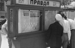 Image: People reading 'Pravda' newspaper on city street in Moscow