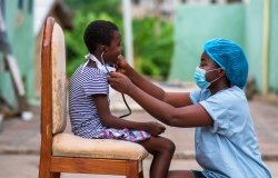 African doctor treating a child